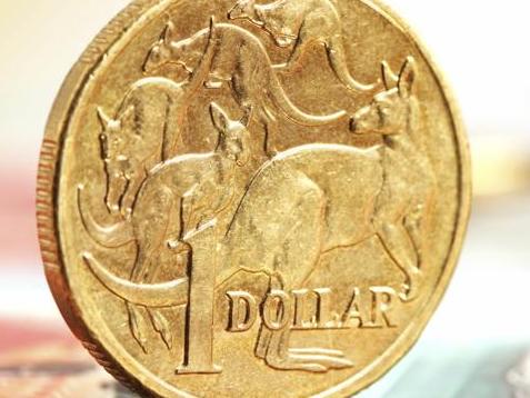 Aussie one dollar coins, on a twenty dollar note.