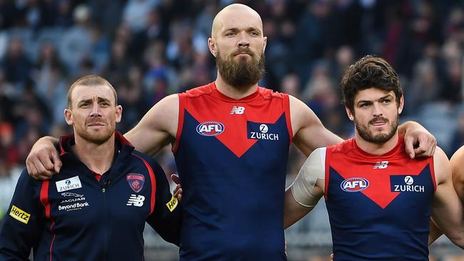 PERTH, AUSTRALIA - SEPTEMBER 10: Melbourne line up for the National Anthem during the 2021 AFL First Preliminary Final match between the Melbourne Demons and the Geelong Cats at Optus Stadium on September 10, 2021 in Perth, Australia. (Photo by Daniel Carson/AFL Photos via Getty Images)