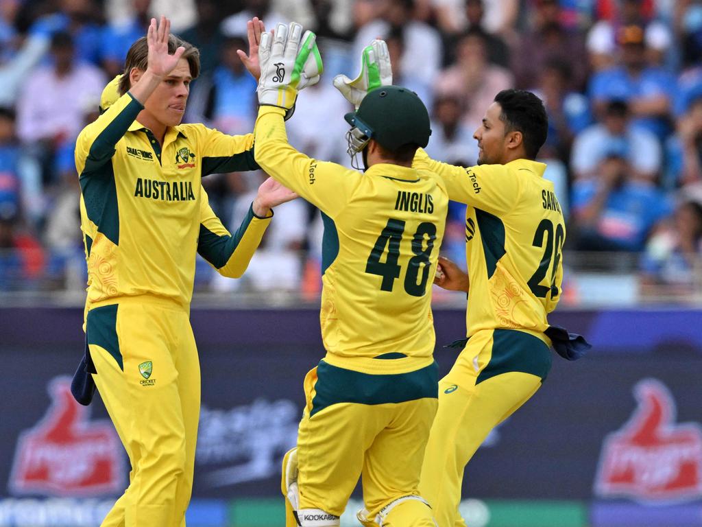 Cooper Connolly (left) celebrates with teammates after taking the wicket of India's captain Rohit Sharma. Picture: Ryan Lim