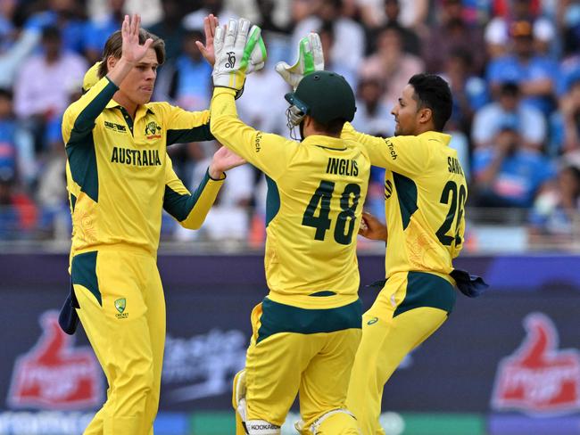 Cooper Connolly (left) celebrates with teammates after taking the wicket of India's captain Rohit Sharma. Picture: Ryan Lim