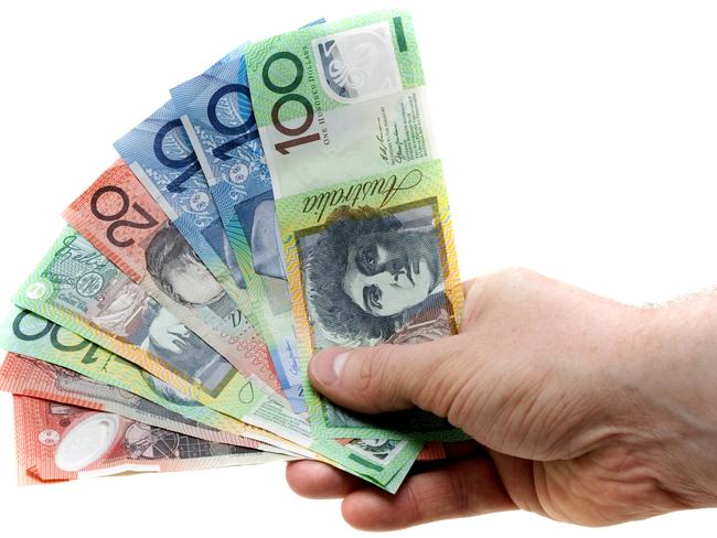 A man's hand holding a wad of Australian banknotes, cash, currency, lending