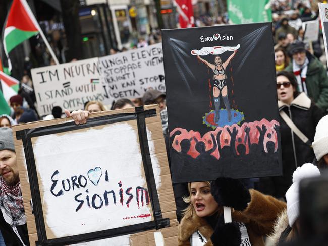 Pro-Palestinian supporters wave flags and carry placards during a demonstration organized by 'Together for Palestine' with demands for cease-fire and to exclude Israel from the Eurovision Song Contest, in central Stockholm, Sweden, on February 17, 2024. (Photo by Fredrik PERSSON / TT NEWS AGENCY / AFP) / Sweden OUT