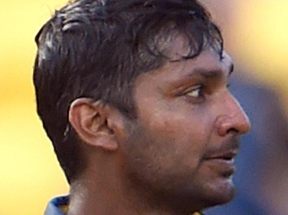Sri Lanka batsman Kumar Sangakkara celebrates scoring a century against England during their 2015 Cricket World Cup Group A match in Wellington on March 1, 2015. AFP PHOTO / William WEST