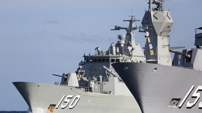 Anzac-class frigate HMAS Anzac, left, which has been taken out of the water indefinitely, passes HMAS Ballarat off Western Australia. Picture: Defence