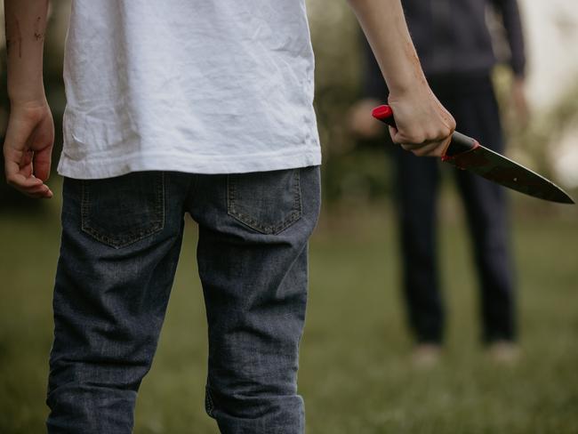 File picture of a youth holding a knife.