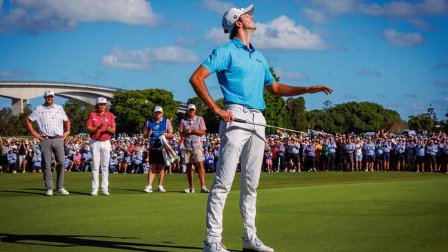 Elvis Smylie reacts to sinking his putt on the 18th green to seal victory in the Australian PGA Championship while Cam Smith and Marc Leishman look on. Photo: AFP