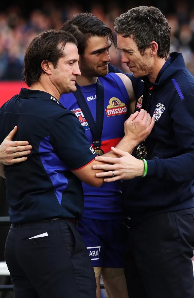 Time to take the cup, but not before a special moment between coach Luke Beveridge, stand-in captain Easton Wood and Bob Murphy. Picture. Phil Hillyard