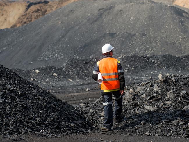 Coal mining in an open pit - Worker is looking on the huge open pit