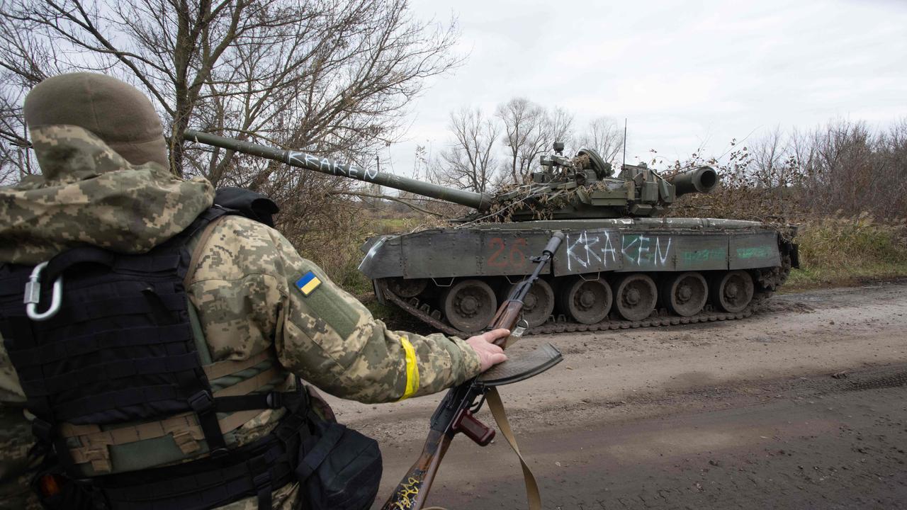 A Ukrainian soldier walks past a destroyed tank near Borivske in the Kharkiv region (Photo by Yevhen TITOV / AFP)