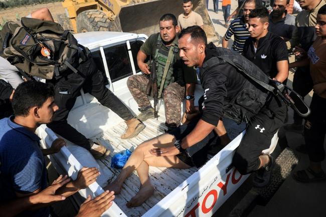 Palestinian militants surround a truck reportedly carrying a captured Israeli woman, in Khan Yunis in the southern Gaza Strip, on October 7, 2023