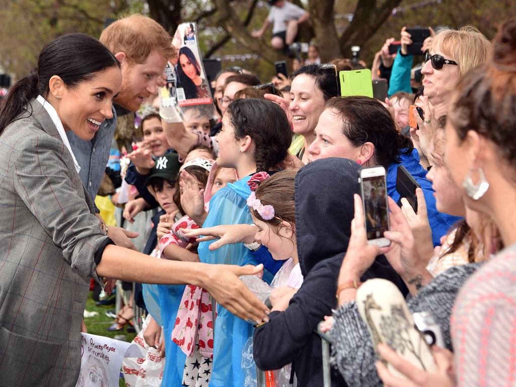 \Harry and Meghan were greeted with hugs and throngs of eager locals brandishing cardboard cut-outs of the couple, royal fancy dress and even a specially brewed beer dubbed ‘Dubbo Royale’. Picture: Peter Parks/AAP