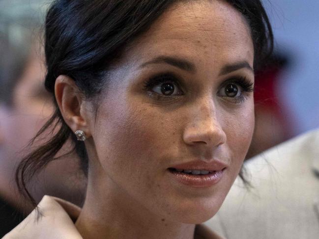 Meghan, Duchess of Sussex gestures during a visit with Britain's Prince Harry, Duke of Sussex to the Nelson Mandela Centenary Exhibition, which explores the life and times of Nelson Mandela and marks the centenary of his birth, at Southbank Centre's Queen Elizabeth Hall in south London on July 17, 2018.  / AFP PHOTO / Arthur Edwards