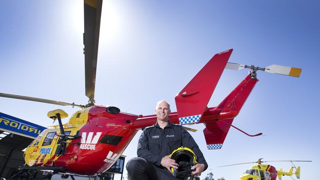 Tasmania Police Senior Crew Instructor Senior Constable Josh Peach with the Westpac rescue helicopter at Hobart. Picture: CHRIS KIDD