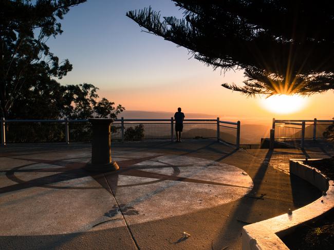 Picnic Point Lookout and Parkland, a Toowoomba heritage listed locale, at sunrise in Queensland, Australia. Man looking at view