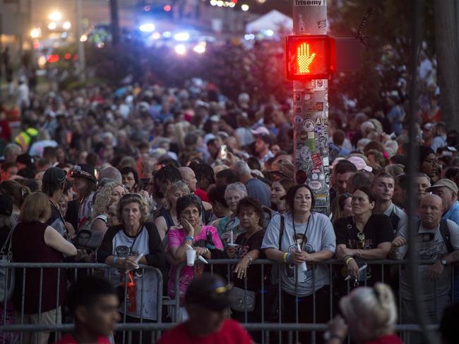 Fans gather at Graceland ahead of the Elvis Presley candlelight vigil held on the eve of his death. The King died 40 years ago on August 16. Picture: AP