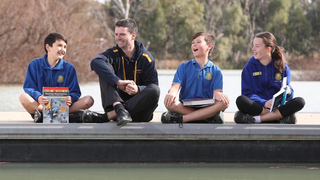 Students Rylan, Jack and Adele with Principal David Ness. Photo: Tait Schmaal.