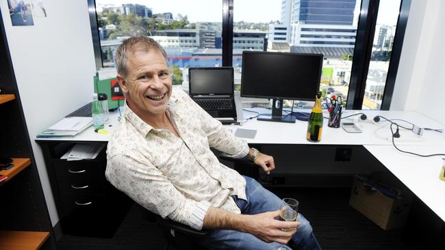 Michael Dempsey relaxes and celebrates at his Newstead office after selling his Ezidebit payment company to Global Payments for AUD $305m. Photo: Claudia Baxter