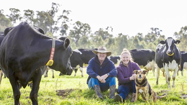 The McNeils run a robotic dairy on their farm at Myall where cows get fresh feed every few hours. They are pictured with their dog Jeremy.