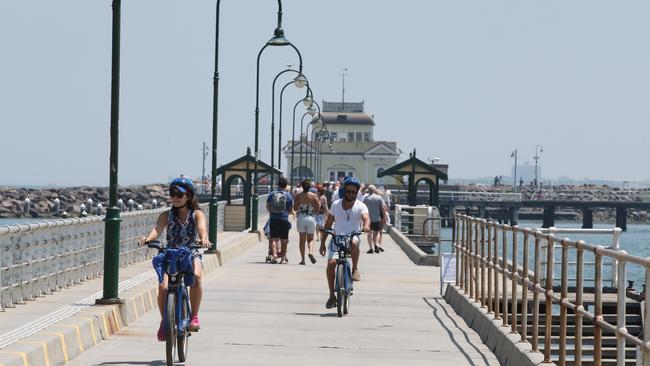 People soak up the sun at St Kilda Pier in Melbourne. Picture: AAP.