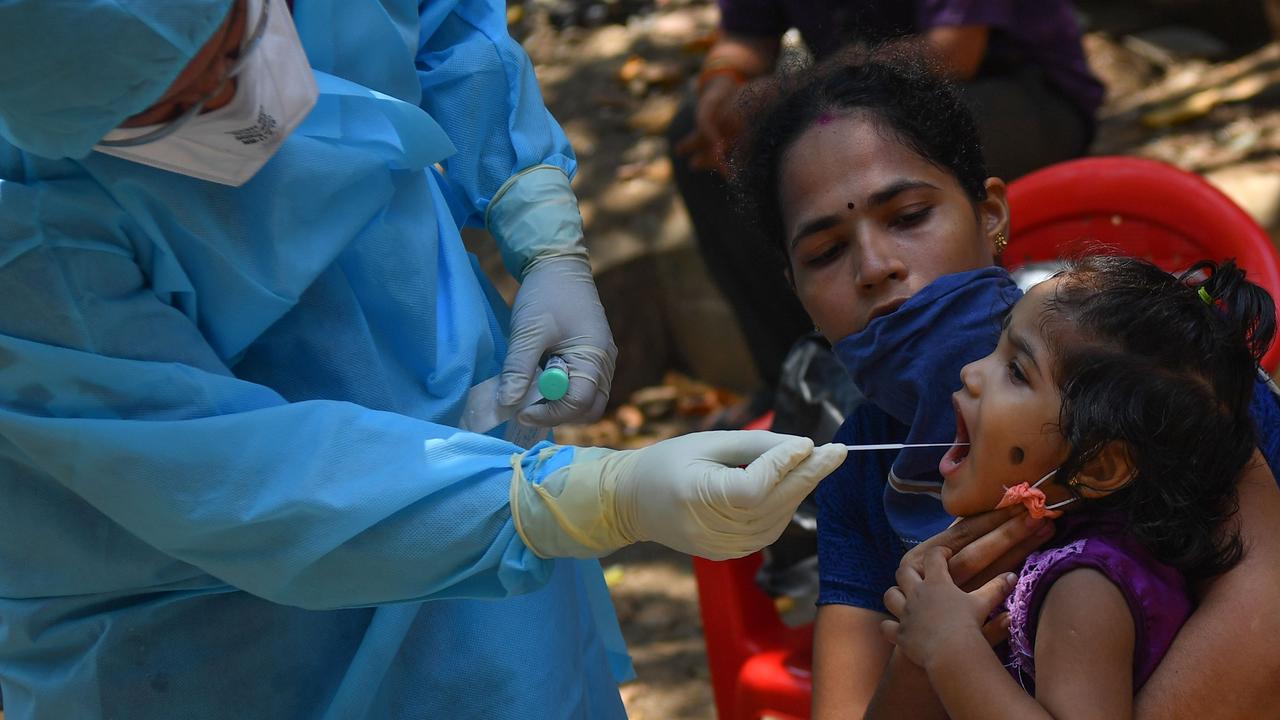 A doctor takes a swab sample of a resident during a COVID-19 coronavirus testing in Mumbai. Picture: AFP.