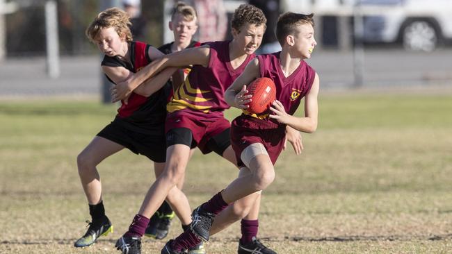 day three of the School Sport SA Sapsasa Country Football Carnival - Year 7 Division 1: Gawler (maroon) v Riverland (red/black) at West Beach , 2 June 2021. Picture Simon Cross