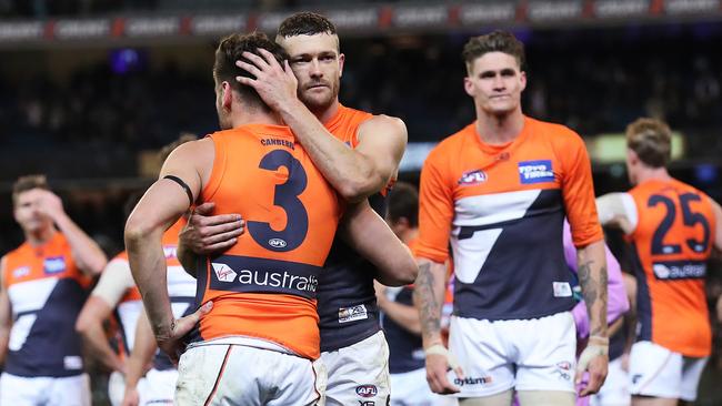 Sam Reid and Stephen Coniglio console each other after the Giants’ loss to Collingwood in the semi-final at the MCG. Picture: Phil Hillyard