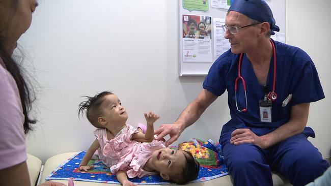 RCH Director of anaesthesia and pain management Dr Ian McKenzie with twins Nima and Dawa. Picture: RCH