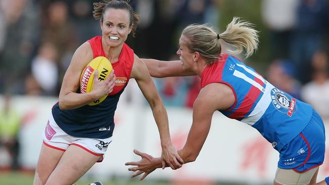 Daisy Pearce brushes past Lauren Spark. Picture: Michael Klein