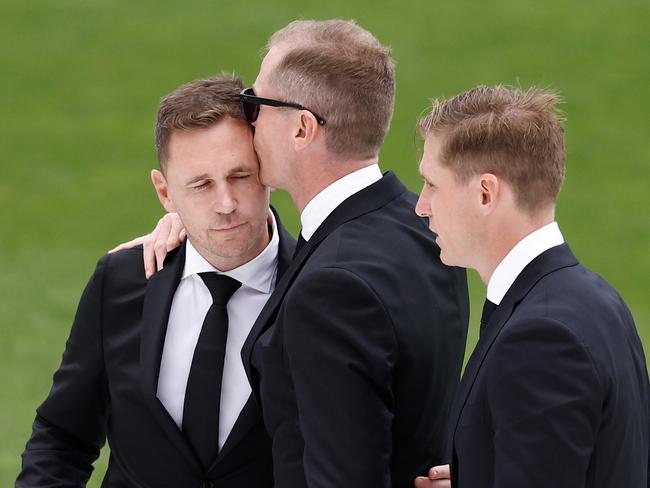 GEELONG, AUSTRALIA - FEBRUARY 14: (L-R) Joel Selwood, Adam Selwood and Scott Selwood embrace during Troy Selwood's Funeral Service at GMHBA Stadium on February 14, 2025 in Geelong, Australia. (Photo by Michael Willson/AFL Photos via Getty Images)