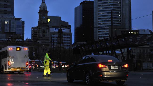 Police direct traffic in Victoria Square after the state lost all power. Picture: AAP Image/David Mariuz