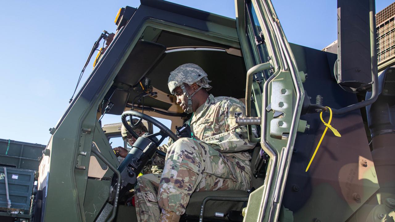 U.S. Army Sgt. Rajaad Howell and Spc. Jon Montgomery, Soldier's assigned to 38th Air Defense Artillery Brigade, 1-1 Air Defense Artillery Battalion, Headquarters and Headquarters Battery, conduct maintenance on their vehicle during port operations for Exercise Talisman Sabre 21, on July 9-10, 2021, at the Port of Gladstone, Queensland, Australia. This is the ninth iteration of Talisman Sabre, a large-scale, bilateral military exercise between Australia and the U.S. involving more than 17,000 participants from seven nations. The month-long multi-domain exercise consists of a series of training events that reinforce the strong U.S./Australian alliance and demonstrate the U.S. MilitaryÃ¢â&#130;¬â&#132;¢s unwavering commitment to a free and open Indo-Pacific. (U.S. Army photo by Staff Sgt. Malcolm Cohens-Ashley, 94th AAMDC Public Affairs).