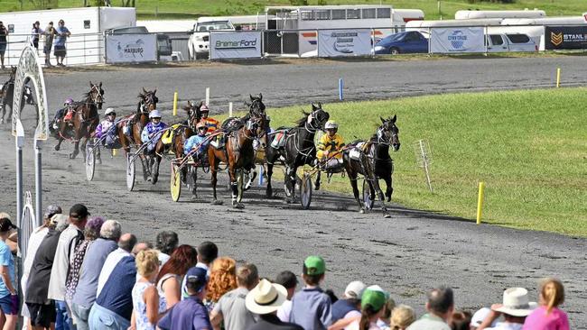 GREAT VIEWING: Racegoers watch intently as drivers jostle for prime position in one of the races at the Easter Sunday meeting at Marburg. Picture: Cordell Richardson