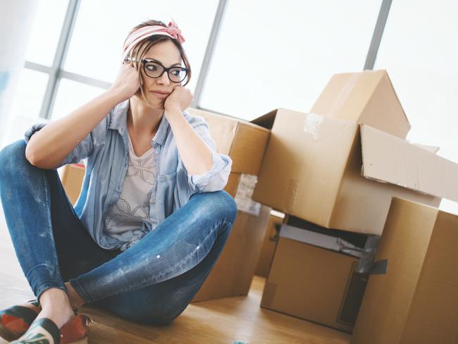 Young woman sitting on the floor, tired of all the work that she done by herself at her apartment. Eviction. Tenant. Renter. Renting. Evicted. Source: iStock - for Herald Sun realestate