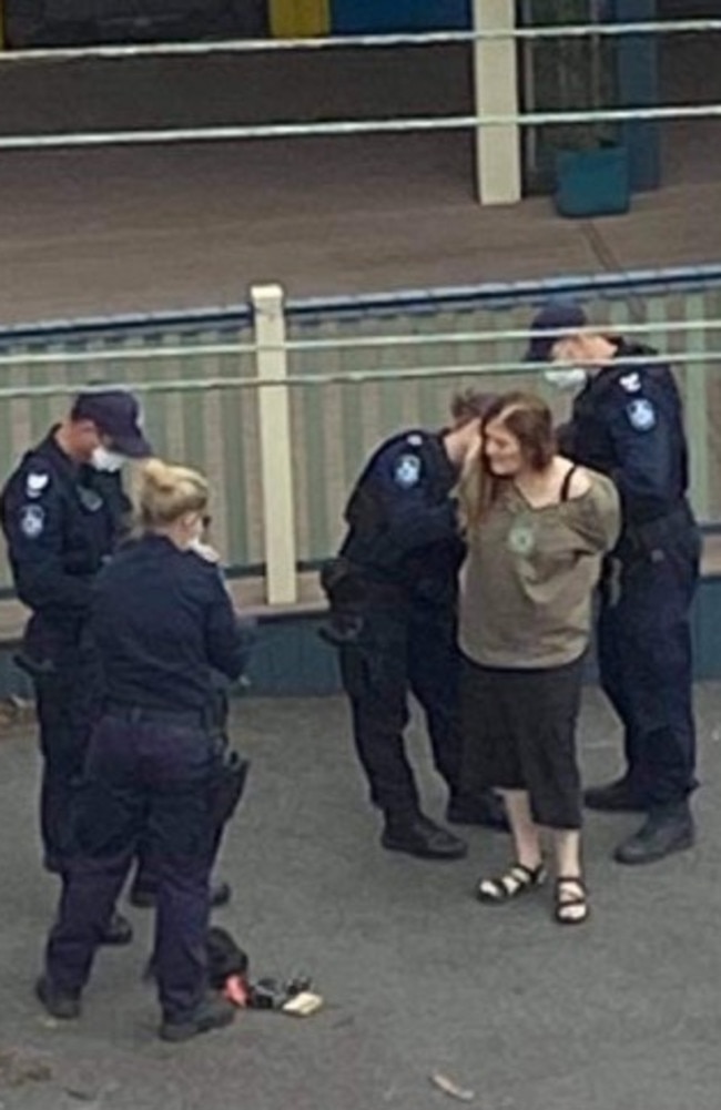 Police arrest a woman without a mask in New Farm. Picture: Supplied