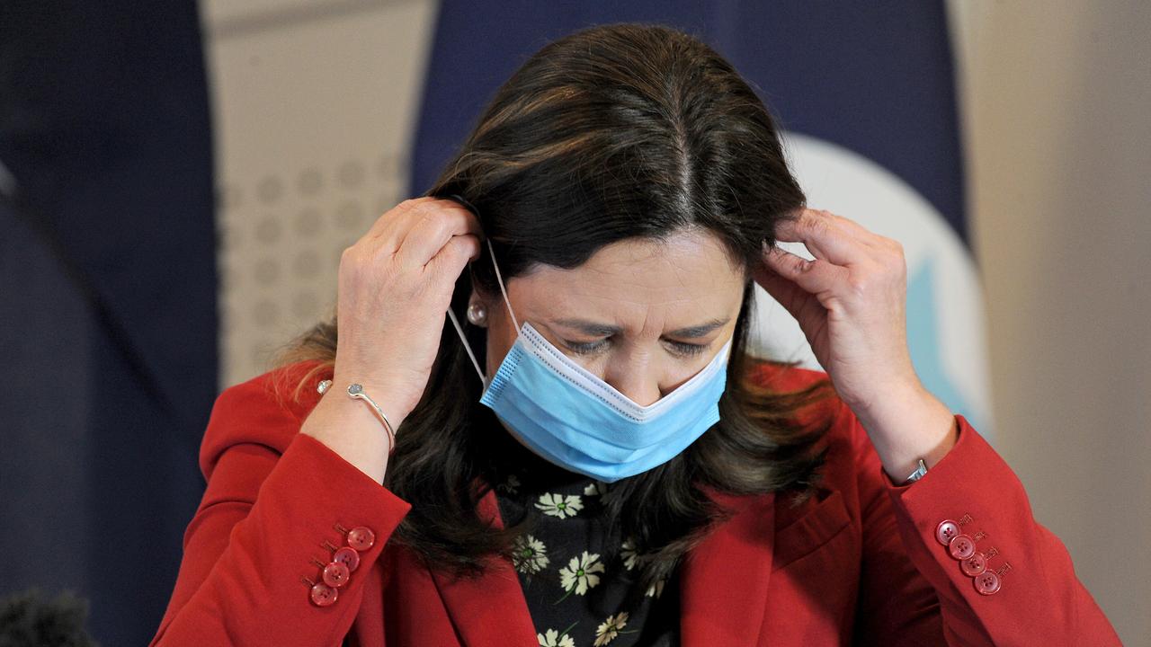 Premier Annastacia Palaszczuk puts her mask on at a press conference about COVID in Brisbane. Picture: NCA NewsWire / John Gass