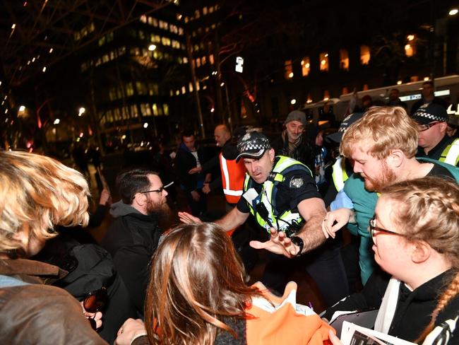 Police push back against protesters outside right-wing UK politician Nigel Farage’s speaking event. Picture: Jake Nowakowski