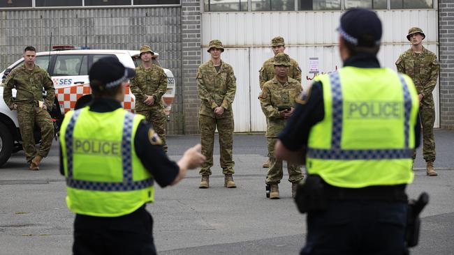 ADF personnel being briefed before conducting compliance checks around Hobart. Picture: CHRIS KIDD