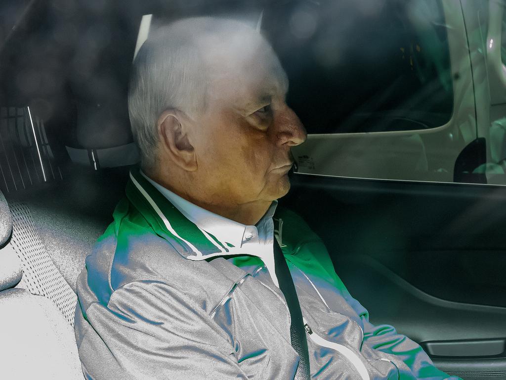 Alan Jones is seen in the back of an unmarked police car as he is transferred to Day St Police Station, in Sydney. Picture: AAP Image/Bianca De Marchi