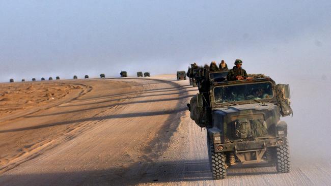 A convoy of US Marines from the 2nd Battalion, 8th Regiment cross the desert northwards near Diwaniya in central Iraq.