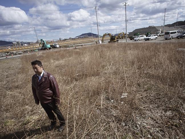 CORRECTS SPELLING OF THE COMPANY - In this Thursday, March 5, 2015 photo, Michihiro Kono, president of Yagisawa Shoten Co., stands at the site of his company's headquarters located before the 2011 tsunami in Rikuzentakata, Iwate Prefecture, northeastern Japan, Thursday, March 5, 2015. The traditional soy-sauce maker, destroyed by the giant tsunami four years ago, has made a comeback, defying tsunami-scale odds. The secret lies in a little white bottle, named 