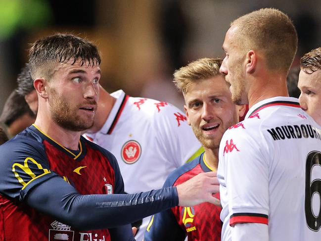 ADELAIDE, AUSTRALIA - JUNE 03: Ryan Strain of Adelaide United speaks with Tass Mourdoukoutas of the Wanderers during the A-League match between Adelaide United and Western Sydney Wanderers at Coopers Stadium, on June 03, 2021, in Adelaide, Australia. (Photo by Daniel Kalisz/Getty Images)