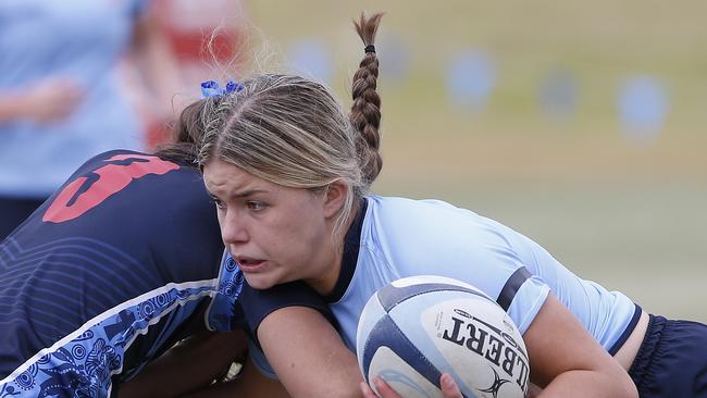 CHS1's Lacey Cross with the ball. Girls Rugby Sevens Grand Final. CHS1 (light blue) v CCC1 (dark blue). Action from game. Junior Rugby. NSW Schools Rugby union trials at Eric Tweedale Oval. Picture: John Appleyard