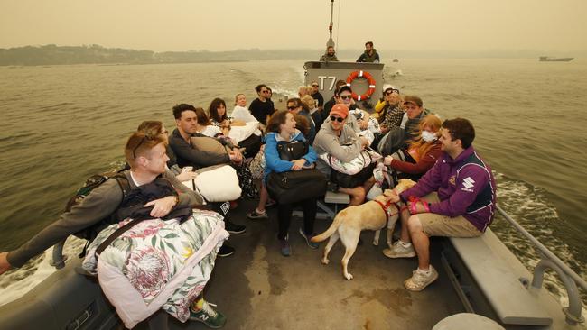 Relief as a boat load of evacuees leaves Mallacoota for HMAS Choules. Picture: David Caird