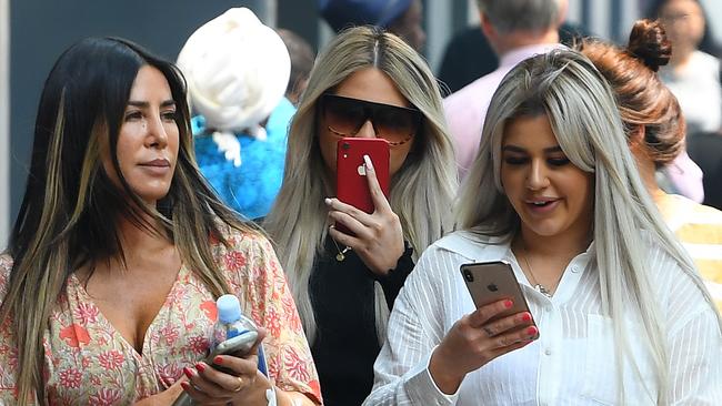 Brittany McGuire (right) arrives at Melbourne Magistrates Court with her mother (left) and friend (centre) yesterday.