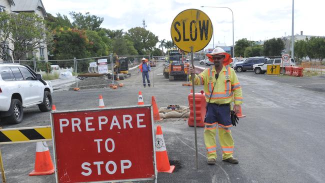 Jerry Dawes from Workforce Road Services controls traffic flow as construction take place for the Clarence Valley's first traffic lights at the intersection of Pound and Clarence streets as part of the new Grafton bridge build.