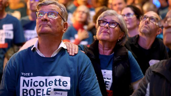People watch the results on a TV at the election night Nicolette Boele event at Buckle Cafe and Distillery in Artarmon. Picture: Damian Shaw
