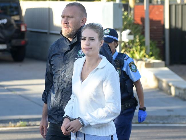 Marjorie Griffiths, after police allowed her to quickly get dressed, outside her home in Umina. Picture: Jeremy Piper