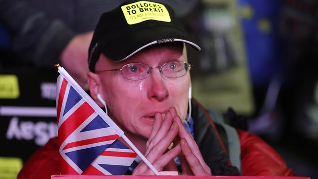 An anti-Brexit demonstrator cries as he gathers with like-minded Brits in Parliament Square in London. Picture: AP