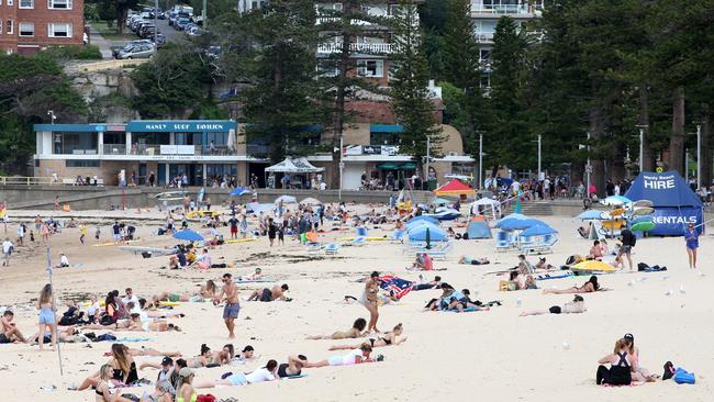 People at Manly Beach in March. The council will set up extra flagged swinmming areas on beaches to help keep people apart. Picture: Damian Shaw