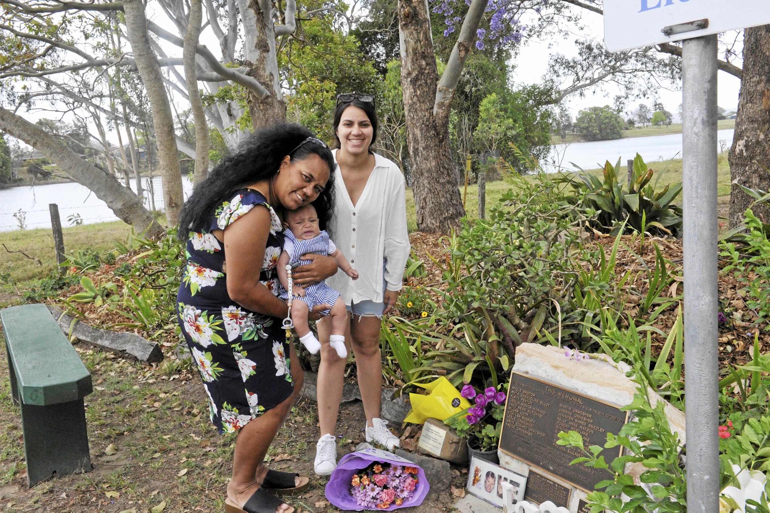 Crash survivor Natisha Pitt at the Cowper memorial with with her daughter Elizabeth and grandson Jarrah.